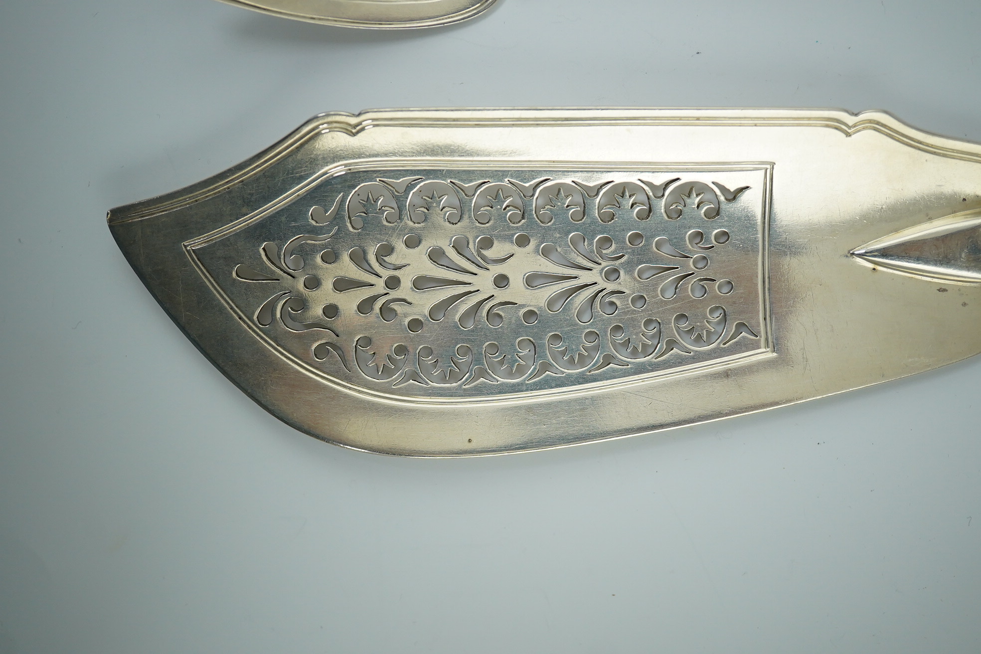 A Victorian silver fiddle, thread and shell pattern fish server and a similar shell pattern fish slice, John James Whiting, London, 1857 and William Eaton, London, 1836 respectively